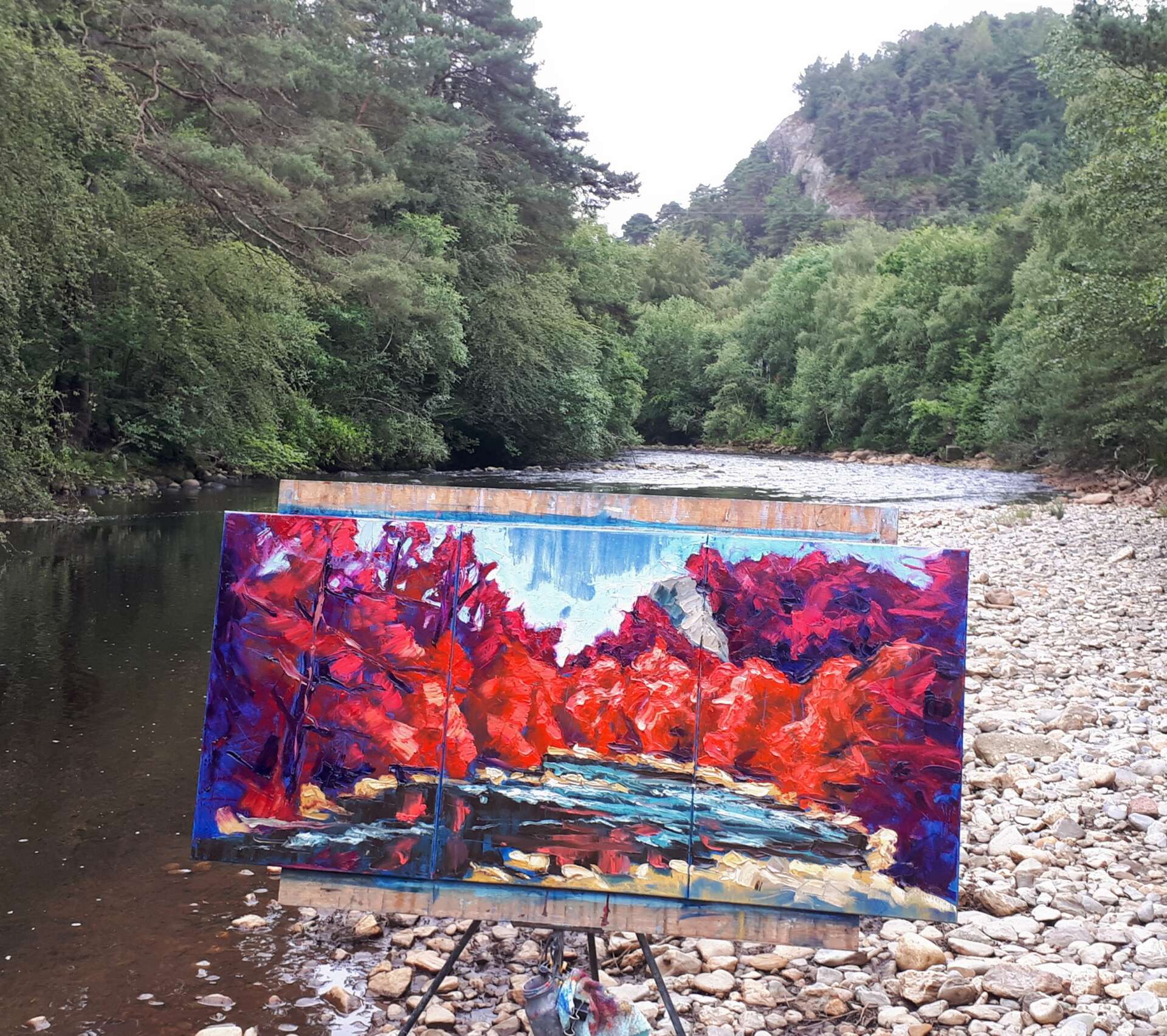 artist rod coyne's triptych painting is shown here on the, just finished on location beside the avoca river.