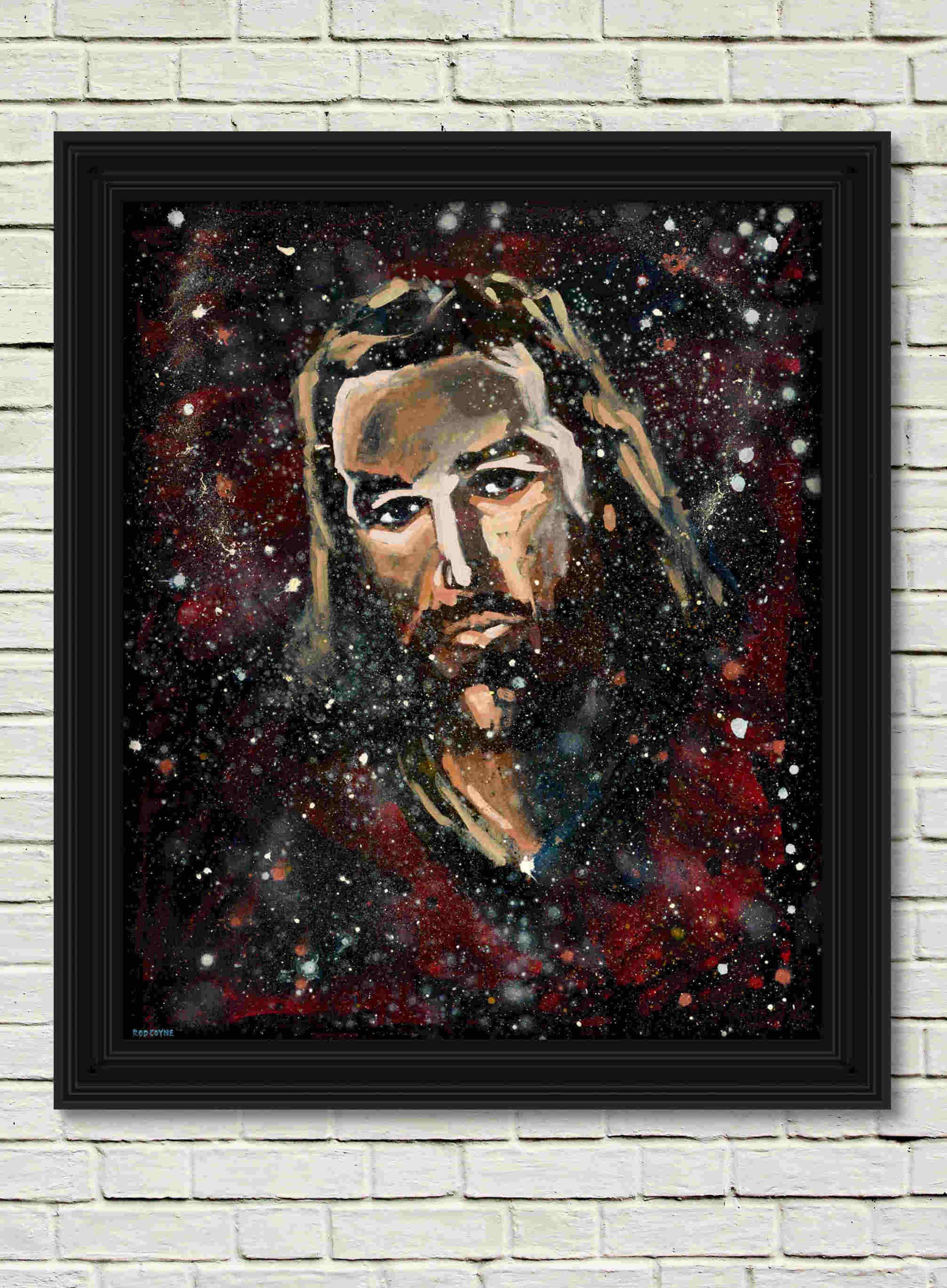 artist rod coyne's portrait "jesus" is shown here, in a black frame on a white wall.